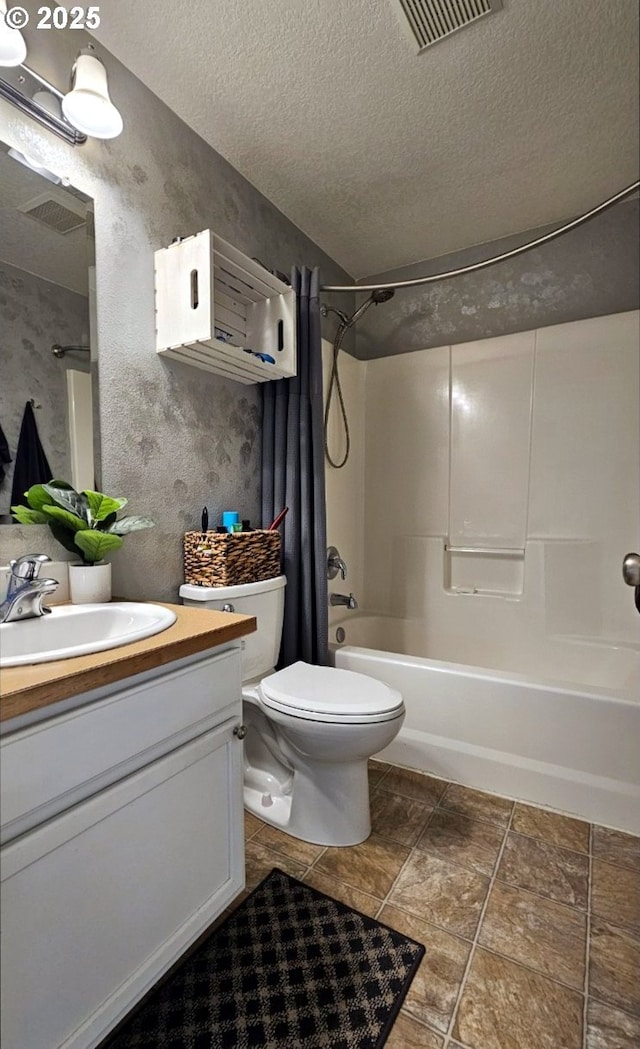 full bathroom with vanity, bathtub / shower combination, a textured ceiling, and toilet