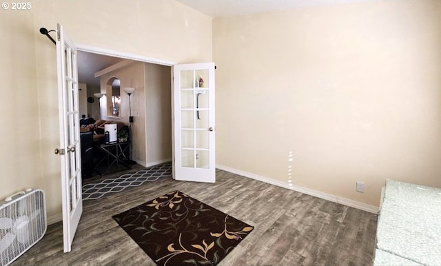 interior space with french doors and wood-type flooring