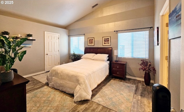 bedroom featuring wood-type flooring and vaulted ceiling