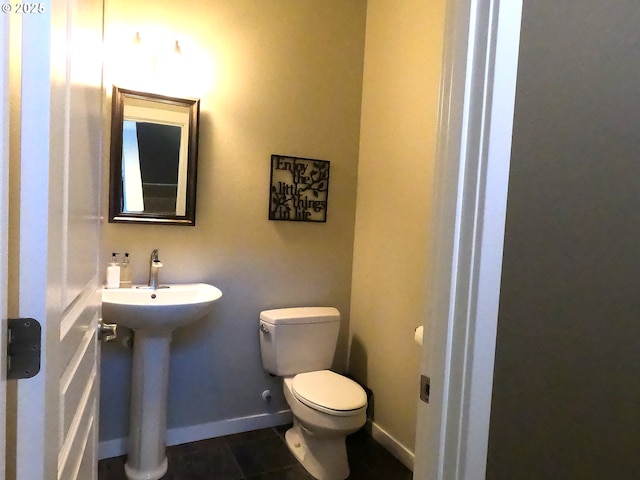 bathroom with tile patterned floors, toilet, and sink