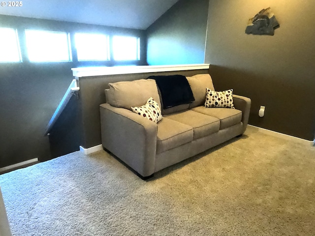 living room featuring lofted ceiling and carpet