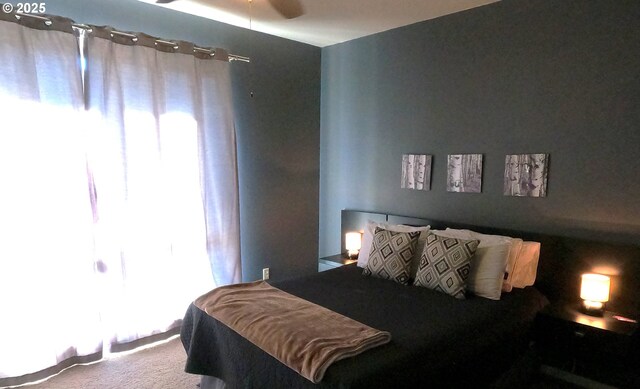 carpeted bedroom featuring multiple windows