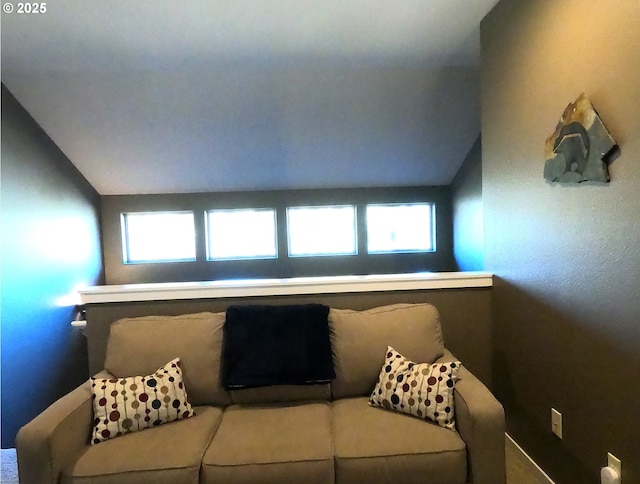 living room featuring lofted ceiling and a wealth of natural light