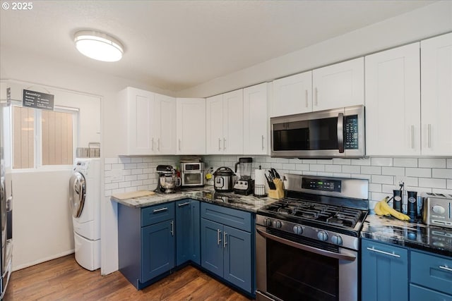 20657 SW Nantucket Ln, Beaverton, OR 97006 - kitchen with stainless steel appliances, blue cabinets, and dark wood-style flooring