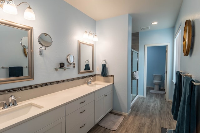 120 Sundance Ct, Roseburg, OR 97471 - full bathroom with a shower stall, wood finished floors, toilet, double vanity, and recessed lighting