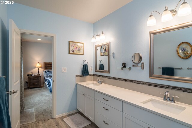 120 Sundance Ct, Roseburg, OR 97471 - ensuite bathroom featuring wood finished floors, double vanity, and tasteful backsplash