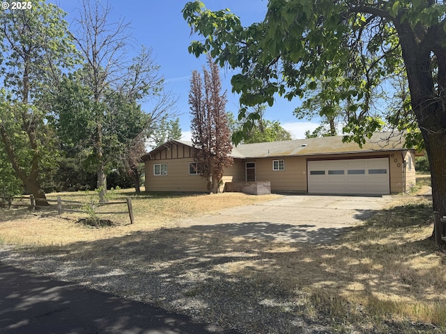 600 NE Oregon Ave, Irrigon, OR 97844 - view of front of home featuring driveway, an attached garage, fence, and board and batten siding