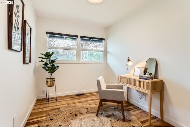 office area featuring baseboards and wood finished floors