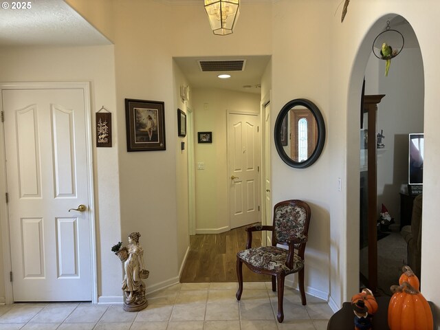 1350 Hidden Creek Dr NE, Keizer, OR 97303 - corridor featuring arched walkways, baseboards, and light tile patterned floors