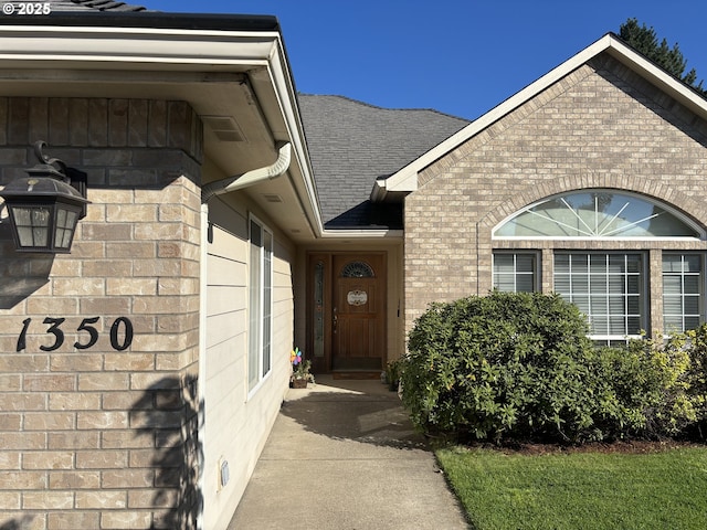 1350 Hidden Creek Dr NE, Keizer, OR 97303 - view of exterior entry featuring brick siding and a shingled roof