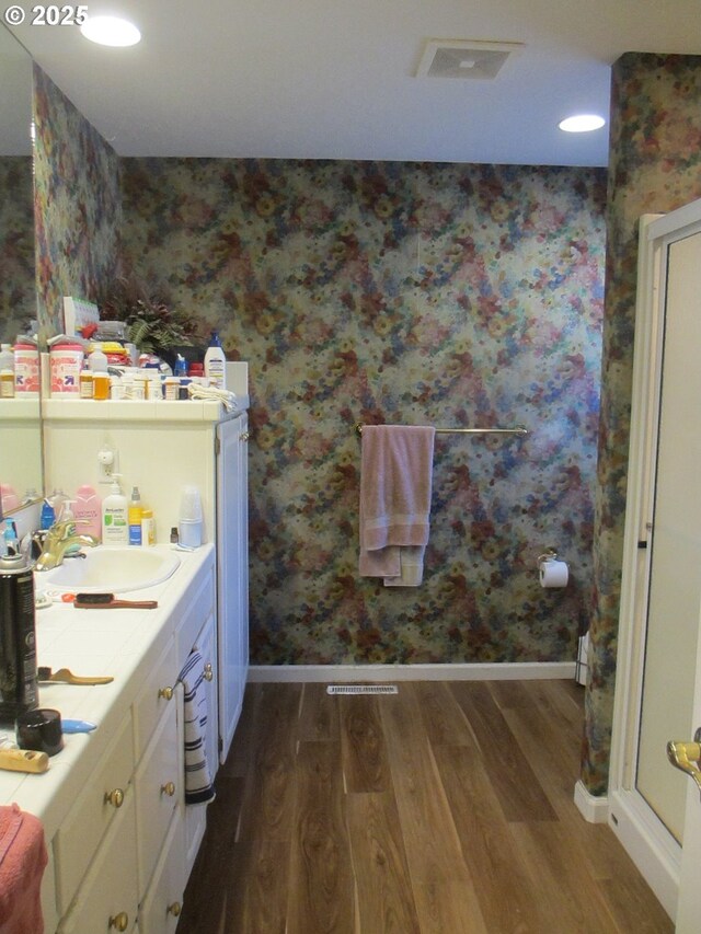 1350 Hidden Creek Dr NE, Keizer, OR 97303 - bathroom featuring wood finished floors, wallpapered walls, baseboards, vanity, and recessed lighting