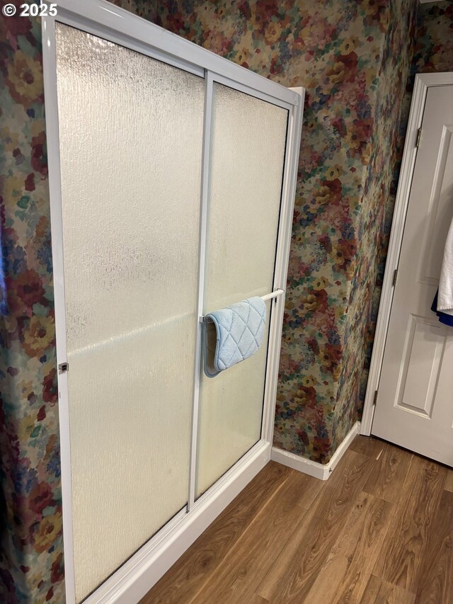 1350 Hidden Creek Dr NE, Keizer, OR 97303 - bathroom with wallpapered walls, wood finished floors, baseboards, and a shower stall