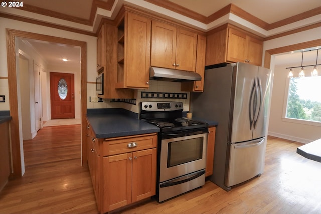 kitchen with stainless steel appliances, dark countertops, brown cabinets, and under cabinet range hood