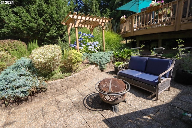 view of patio / terrace featuring an outdoor living space with a fire pit, a deck, and a pergola