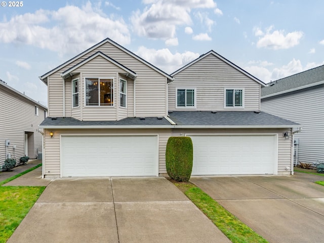 view of front of home featuring driveway, an attached garage, and a shingled roof