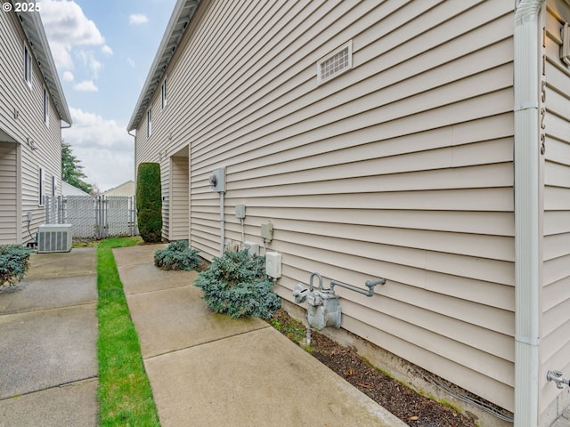 view of home's exterior featuring a patio, cooling unit, and fence