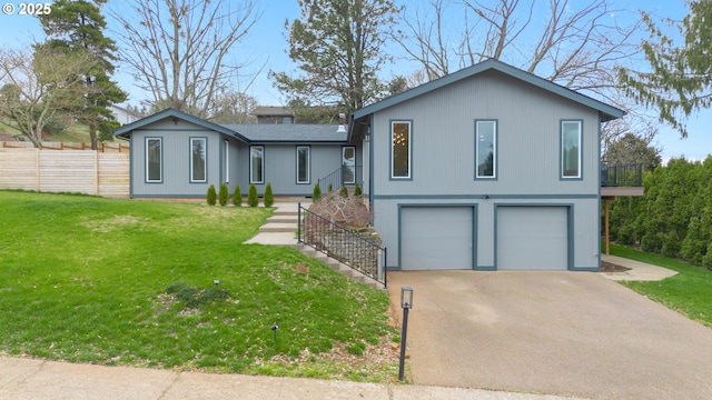 view of front facade with a front lawn, fence, concrete driveway, a shingled roof, and a garage