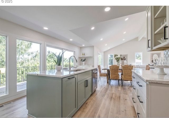 kitchen featuring visible vents, vaulted ceiling with beams, dishwasher, light wood-type flooring, and a sink