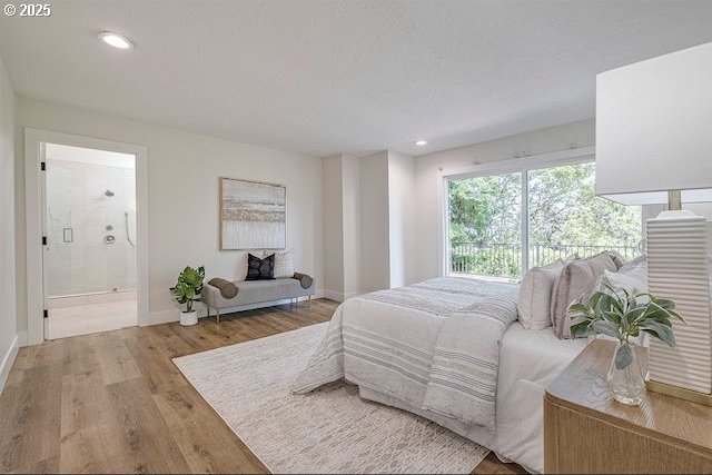 bedroom featuring recessed lighting, connected bathroom, baseboards, and wood finished floors