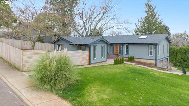 single story home with a shingled roof, a front lawn, and fence