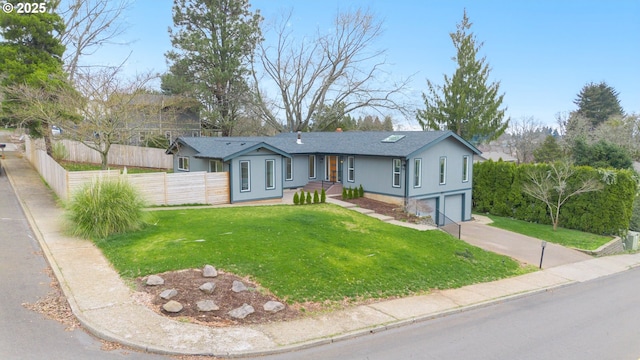 ranch-style home with a front yard, fence, driveway, an attached garage, and a shingled roof