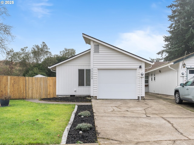 view of front of property featuring a garage and a front lawn