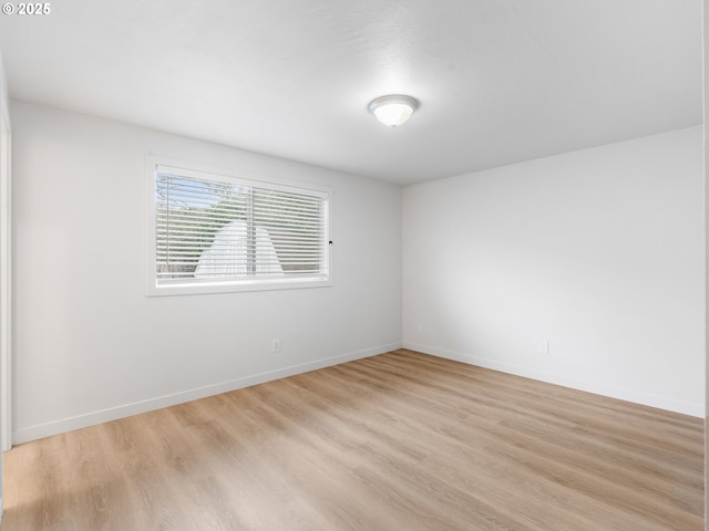 unfurnished room with light wood-type flooring