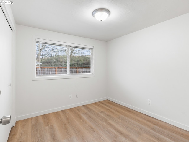 empty room with light hardwood / wood-style floors