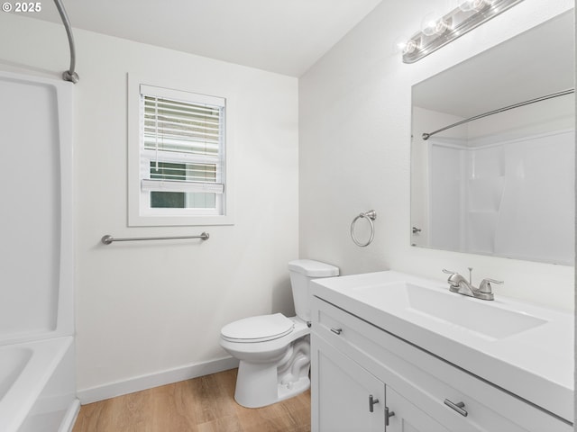 full bathroom with toilet, vanity, hardwood / wood-style floors, and tub / shower combination