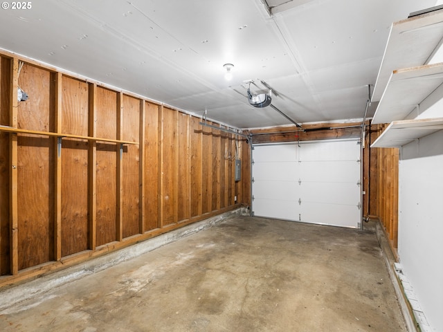 garage with electric panel and a garage door opener