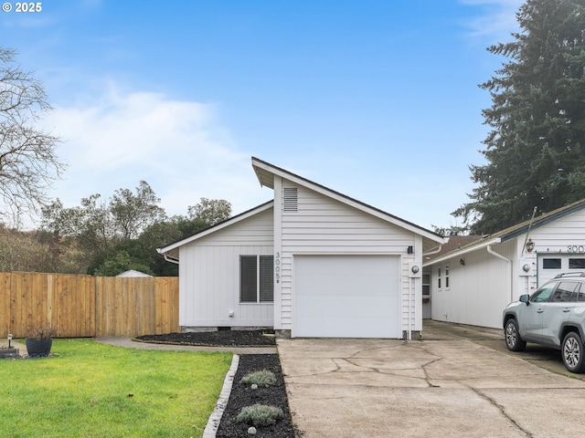 view of front of property with a garage and a front yard