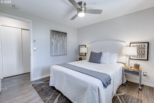 bedroom with baseboards, ceiling fan, and wood finished floors