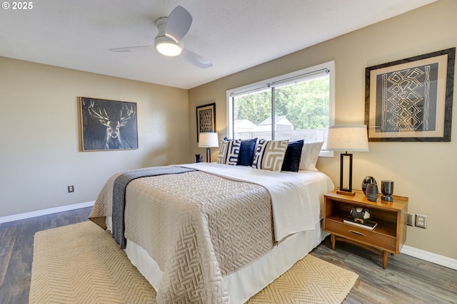 bedroom featuring baseboards, ceiling fan, and wood finished floors
