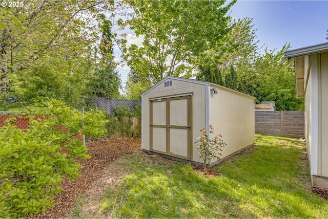 view of shed with fence
