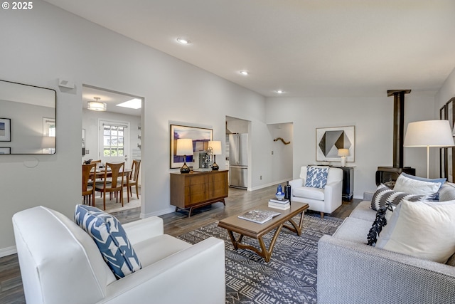 living area featuring baseboards, recessed lighting, and wood finished floors