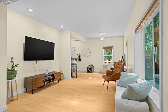 living room with baseboards, recessed lighting, and wood finished floors