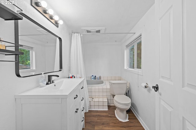 bathroom featuring visible vents, curtained shower, wood finished floors, vanity, and toilet