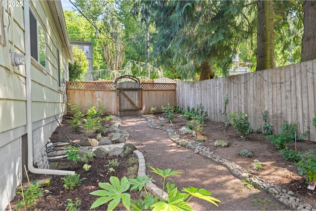 view of yard featuring a gate and a fenced backyard