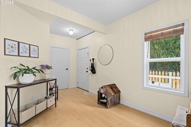 foyer featuring baseboards and light wood finished floors