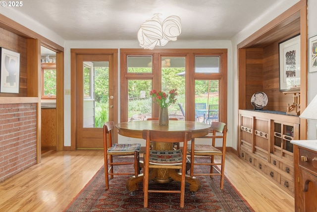 dining room featuring light wood-style floors and baseboards