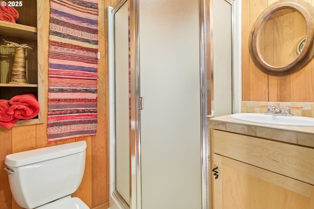 bathroom featuring vanity, a stall shower, and toilet