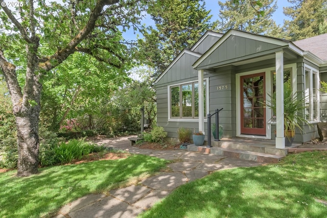 view of front of home featuring board and batten siding and a front lawn