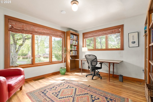 office with baseboards, wood finished floors, and visible vents