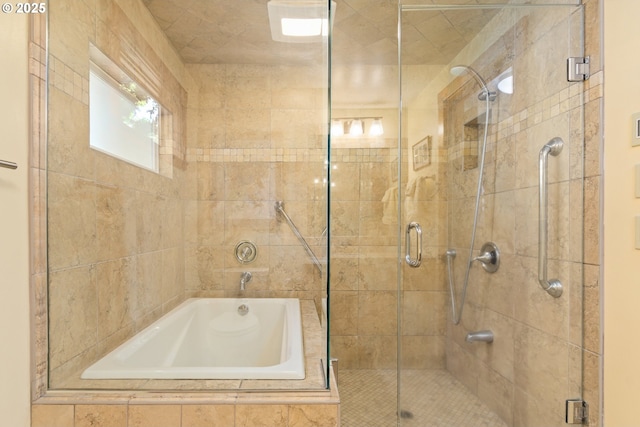 bathroom with tiled bath and a tile shower
