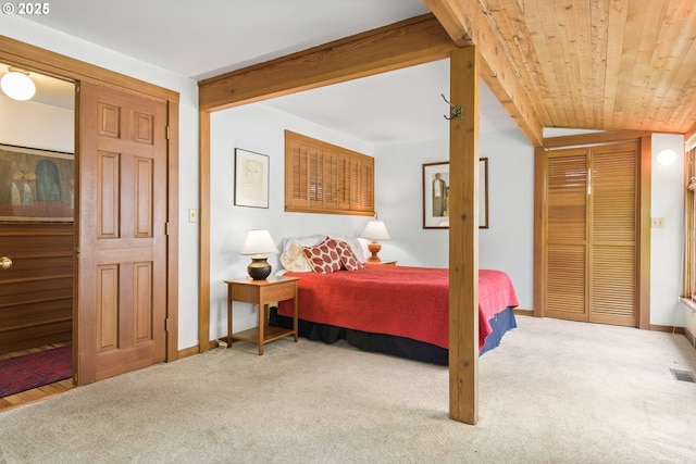 carpeted bedroom with wooden ceiling, baseboards, and visible vents