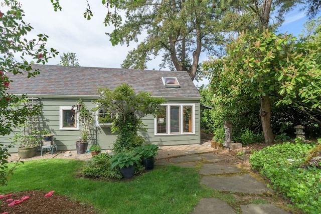 view of home's exterior featuring roof with shingles