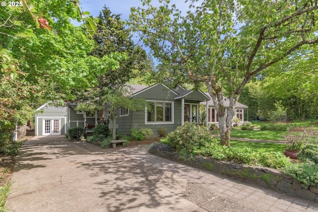 view of front facade with french doors and driveway