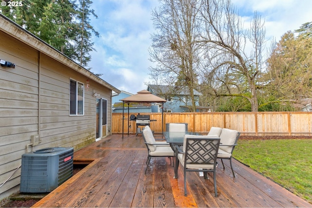 deck featuring cooling unit, a grill, a gazebo, and a yard