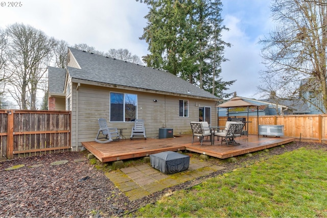 rear view of house featuring a gazebo, a yard, a deck, and central air condition unit