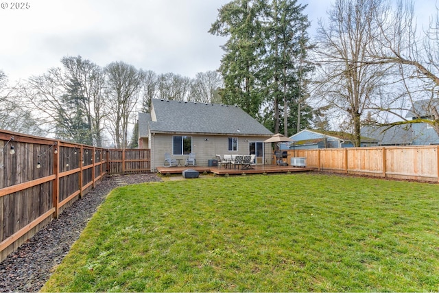 back of house featuring a wooden deck, central AC unit, and a lawn